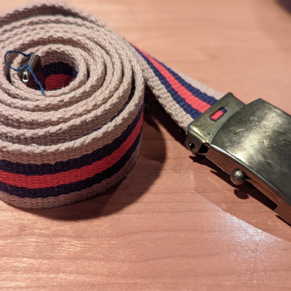 Fabric retro belt in red, blue and tan with metal buckle. Made in the USA.